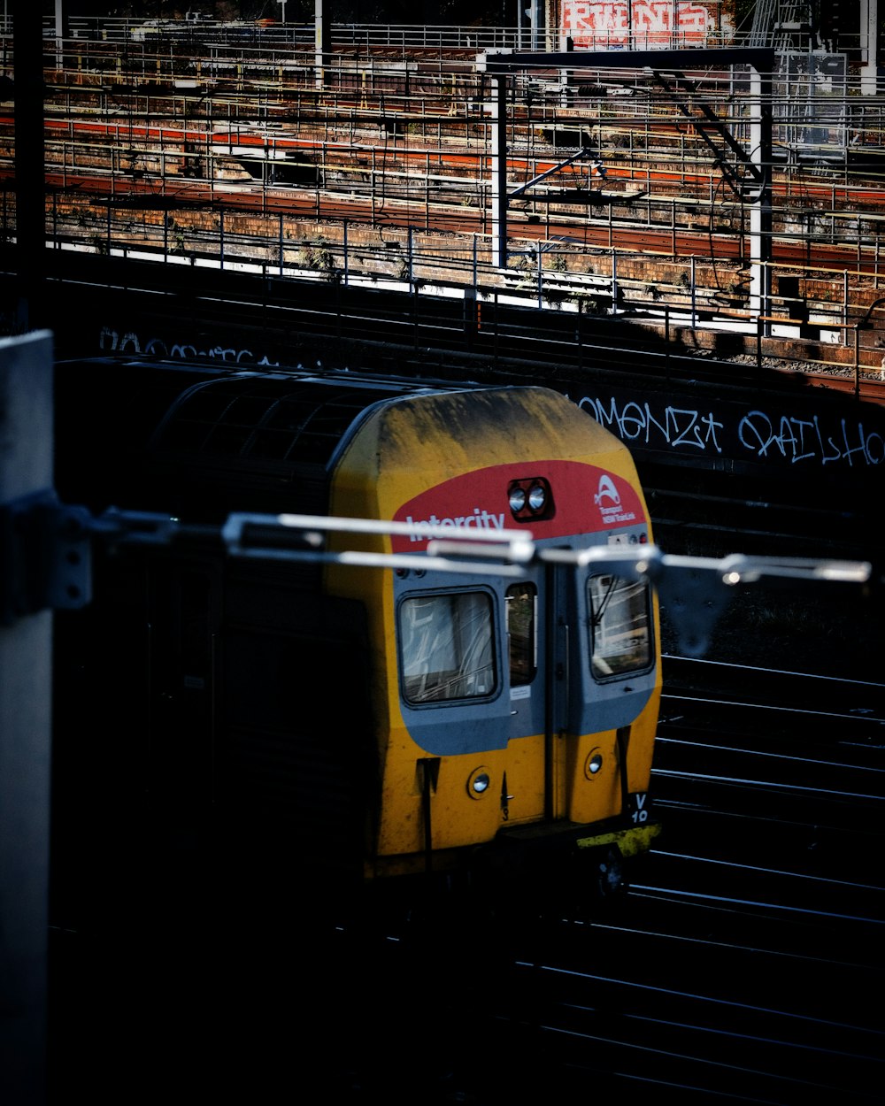 selective focus photography of yellow train on railway