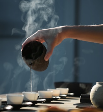 person pouring hot water on white cup