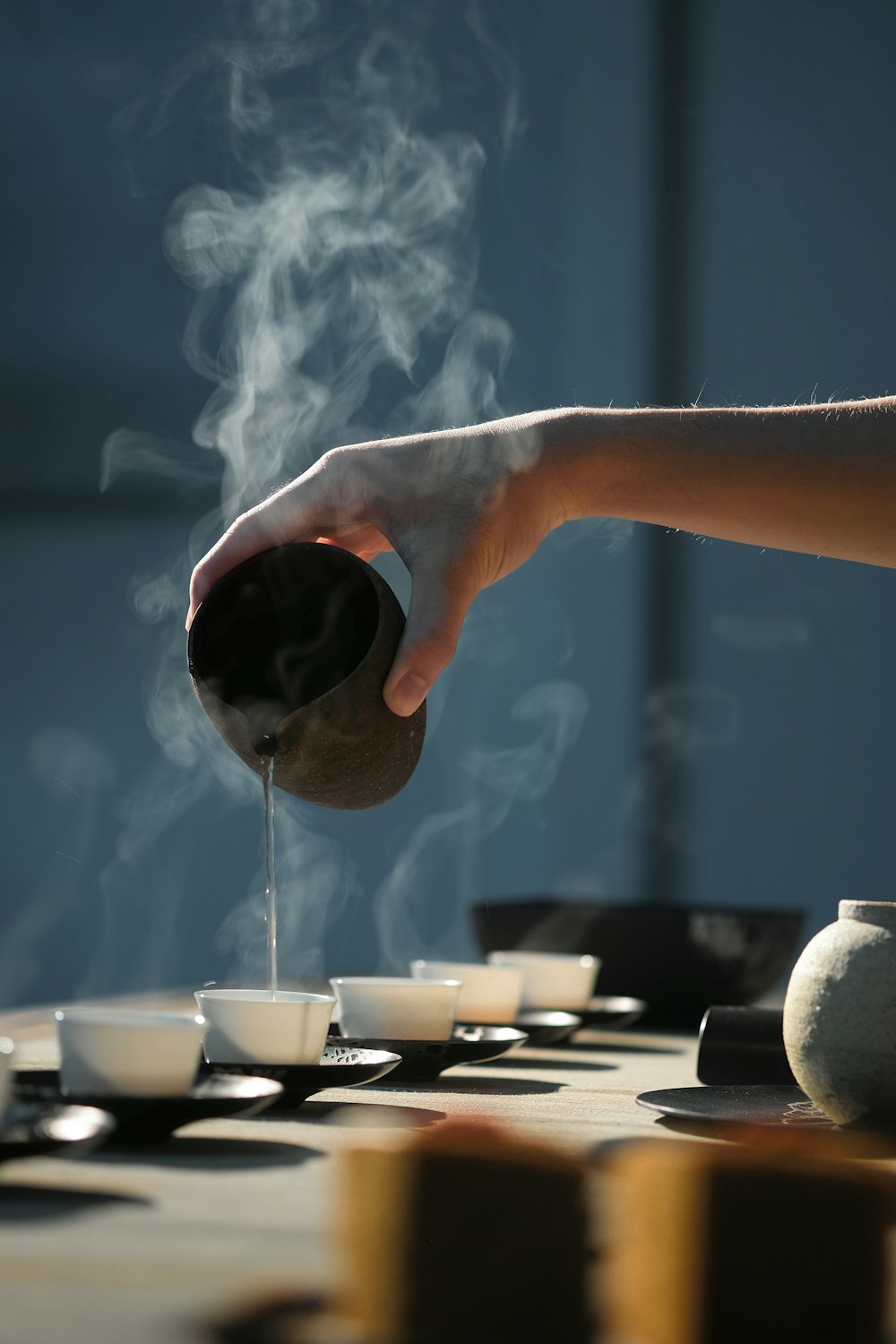 person pouring hot water on white cup