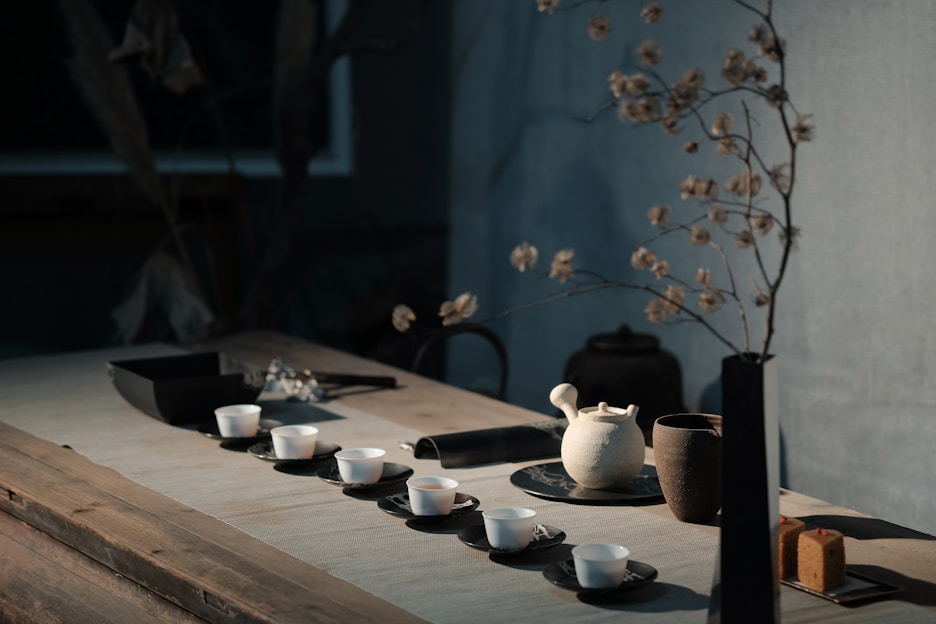 A beautifully arranged minimalist ceramic tea set with soft natural lighting highlighting its smooth texture.