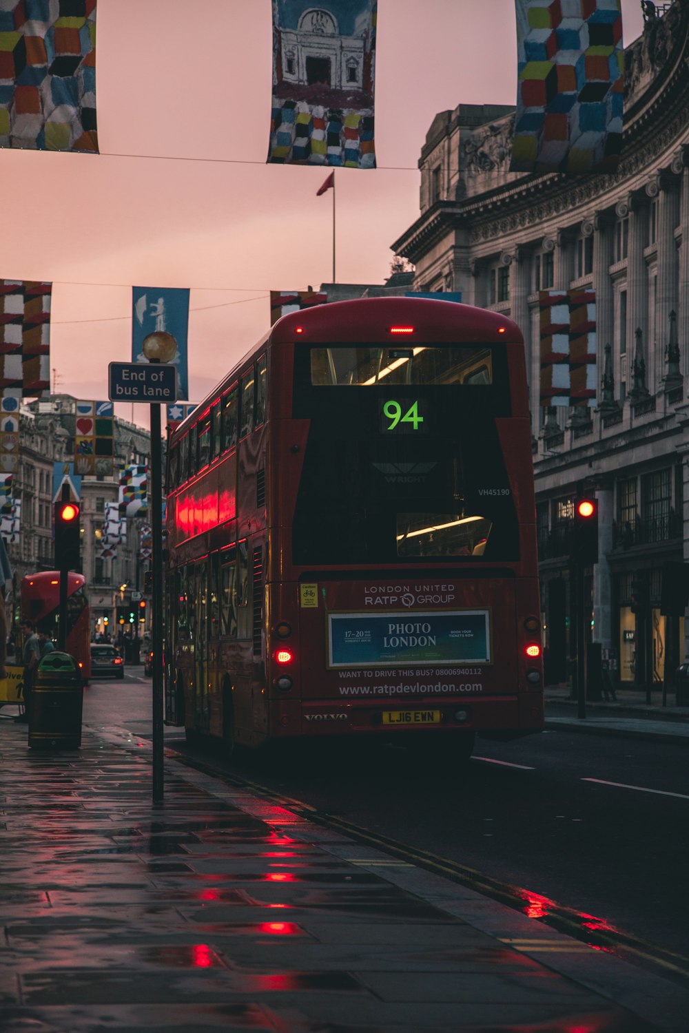 red bus parking beside walkway