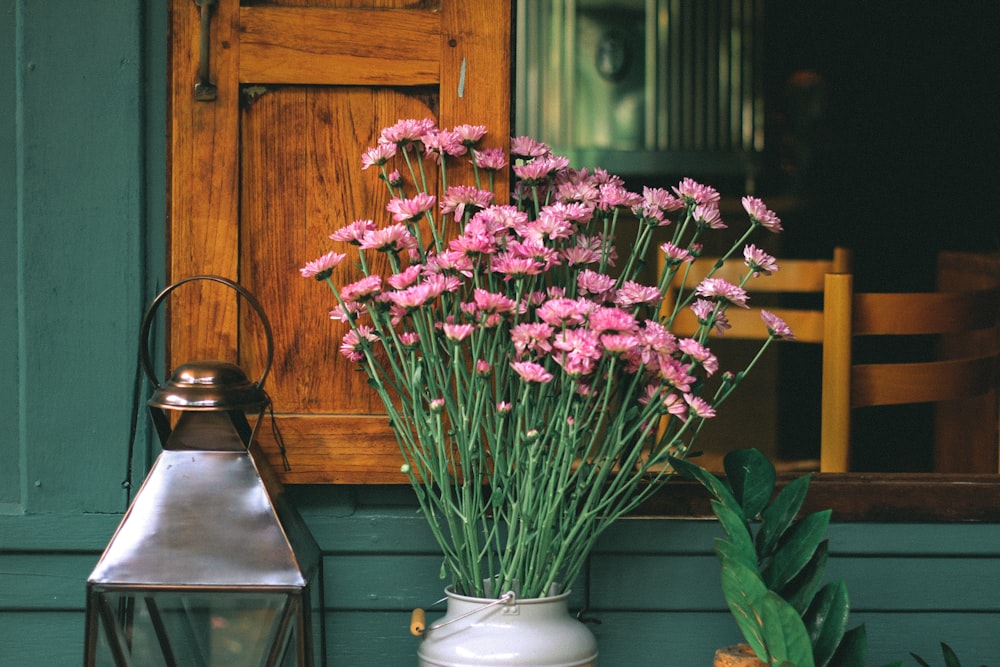 pink gerbera daisies on milk churn