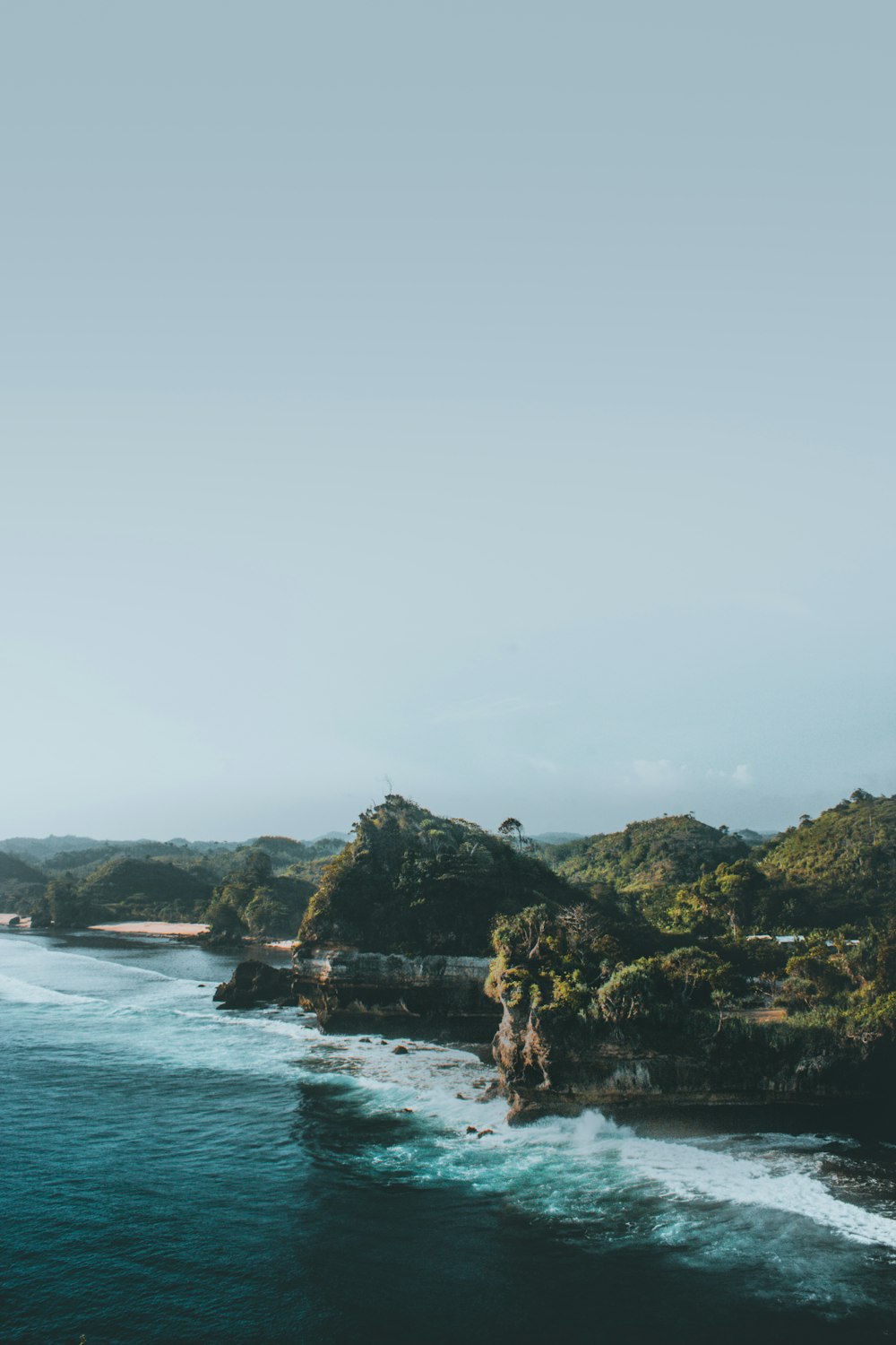 ocean near mountains during daytime