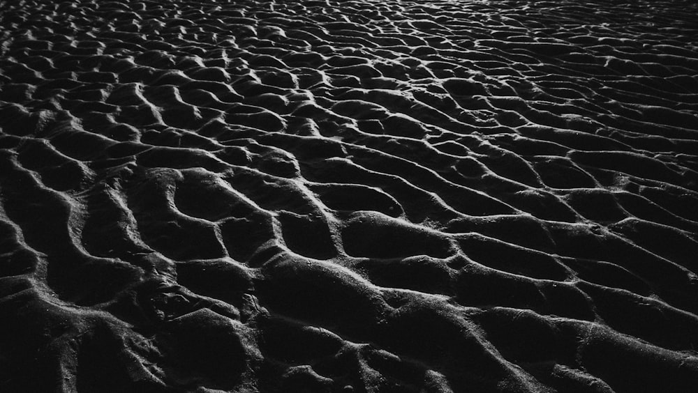 a black and white photo of a sandy beach