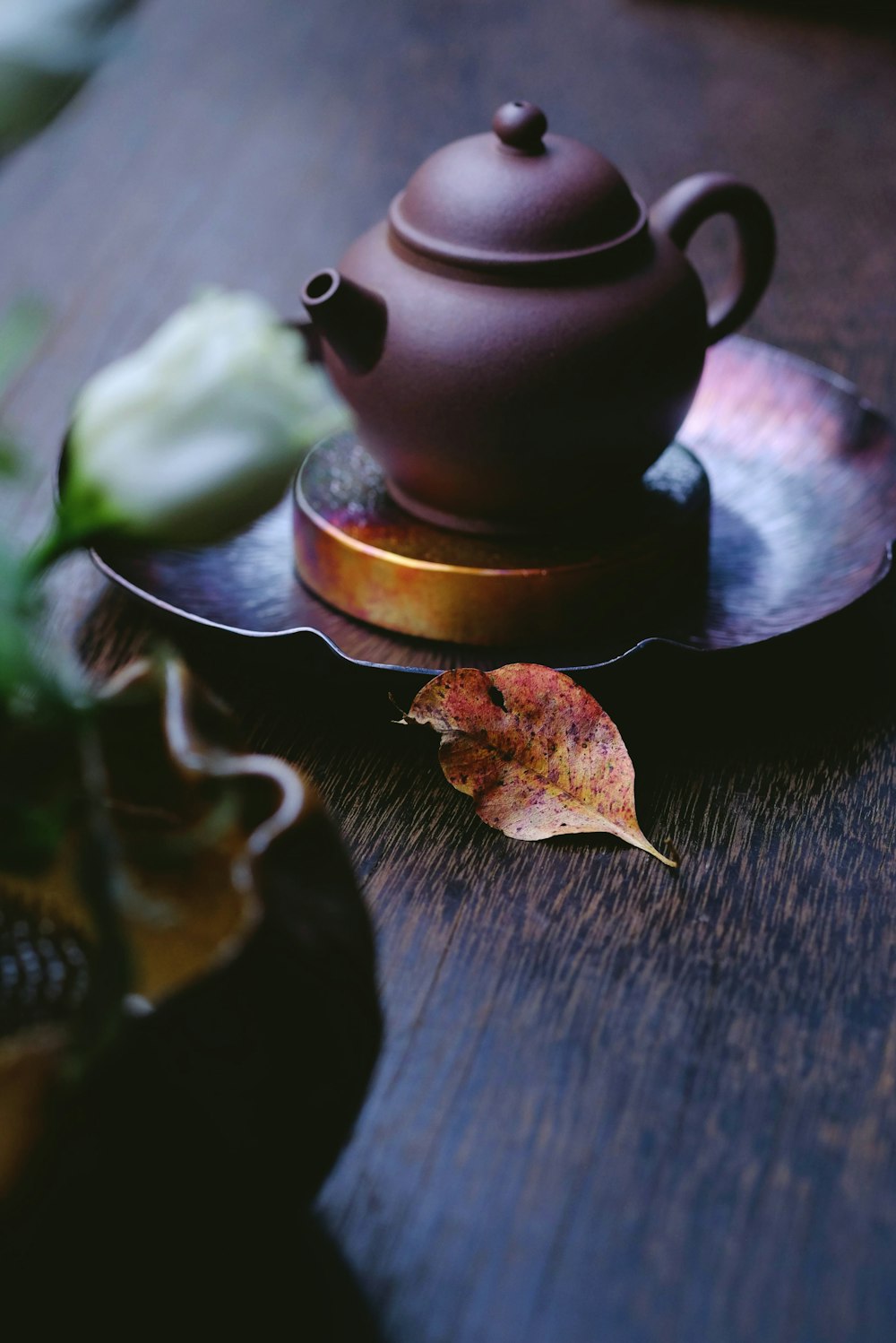 brown kettle on saucer