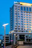 Evening view of the hotel exterior showcasing its clean, modern lines.