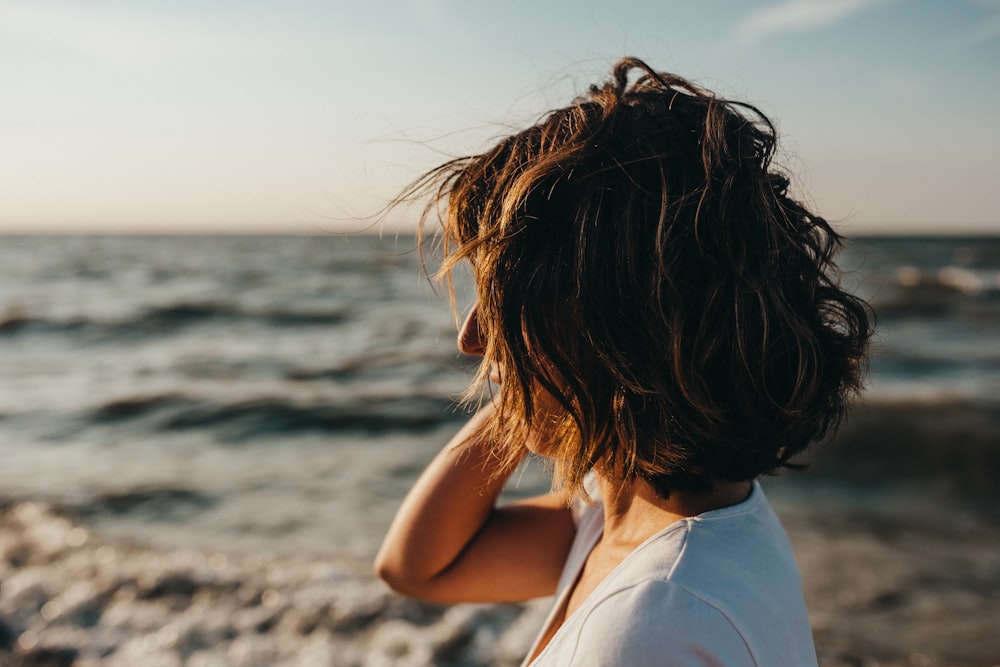 selective focus photography of woman near shoreline