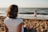 woman watching child playing on beach during daytime