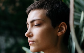 person standing in front of green plants