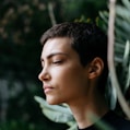 person standing in front of green plants