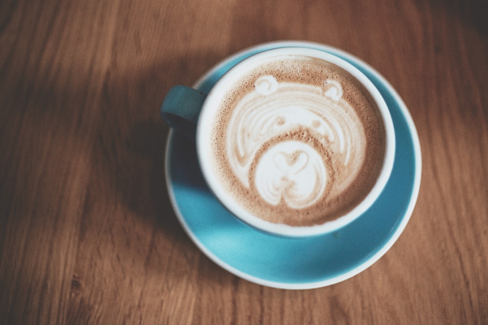 blue ceramic coffee mug on saucer