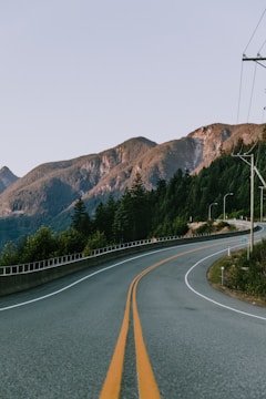 photo of winding road near mountain