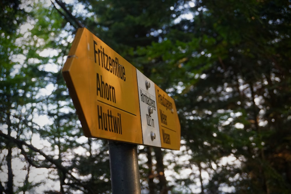 white and yellow metal road signage