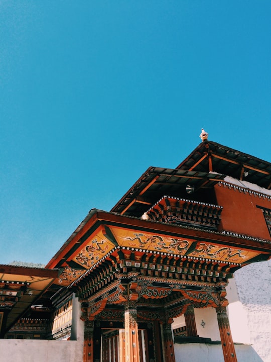 brown and black temple with clear sky in Thimphu Bhutan