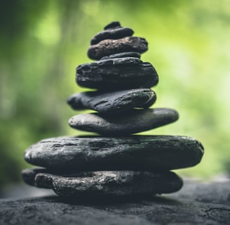 black stacking stones on gray surface