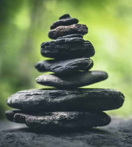 black stacking stones on gray surface