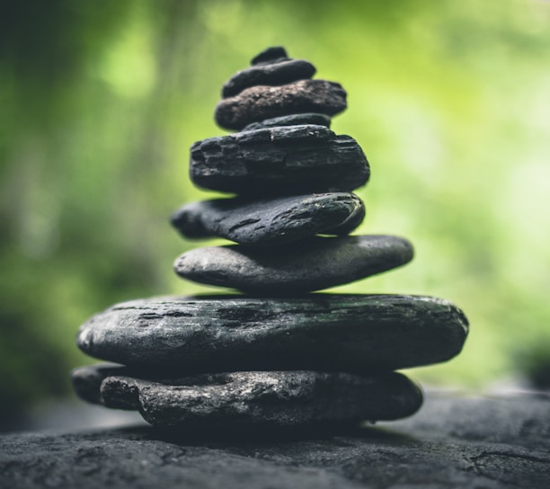 black stacking stones on gray surface