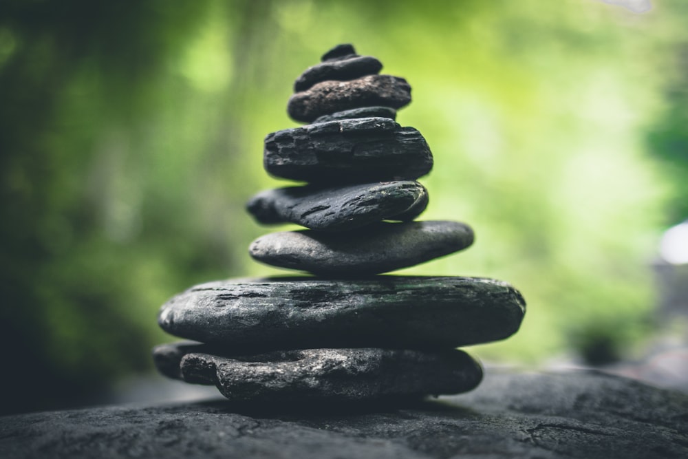 black stacking stones on gray surface