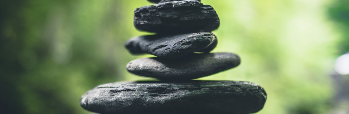 black stacking stones on gray surface