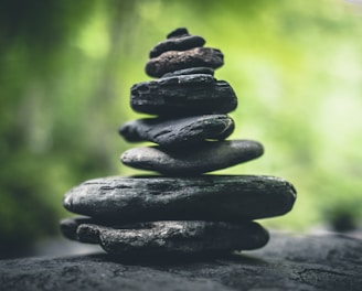 black stacking stones on gray surface