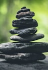 black stacking stones on gray surface