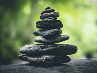 black stacking stones on gray surface