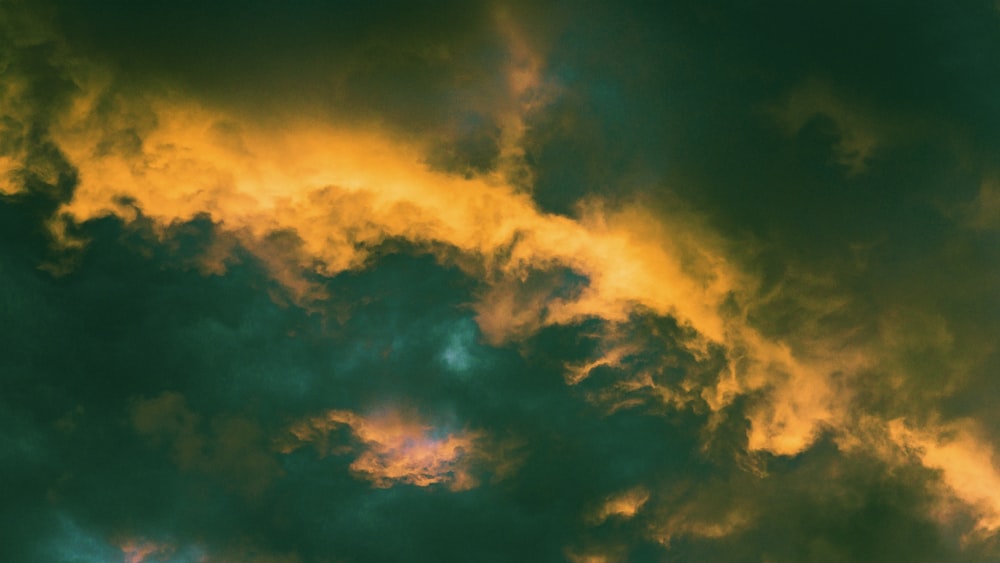 a plane is flying through a cloudy sky