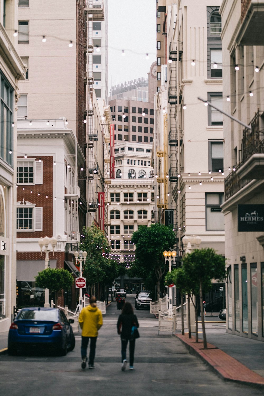 man and woman walking on the street during daytime