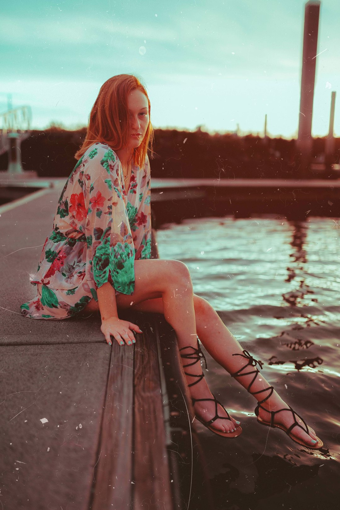 woman sitting near body of water