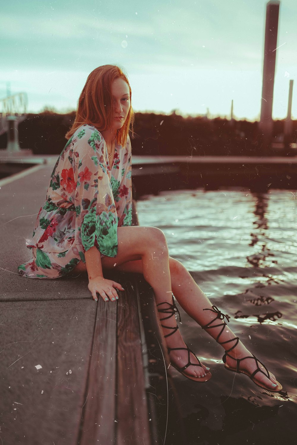 woman sitting near body of water