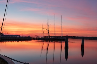 A calm harbor scene at sunset with a merchant vessel docked, symbolizing connection and communication.