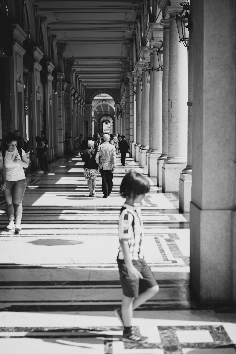 grayscale photo of people in hallway