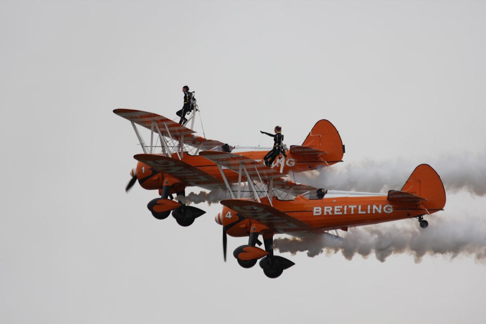 two orange-and-white Breitling airborne