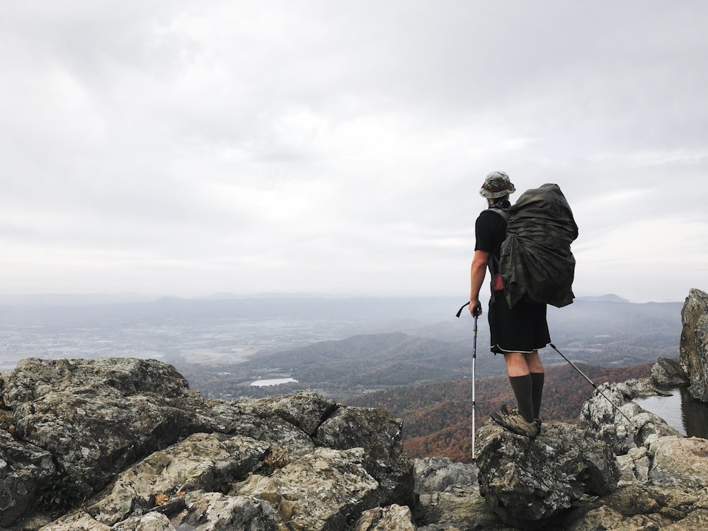 man standing on top of mountain