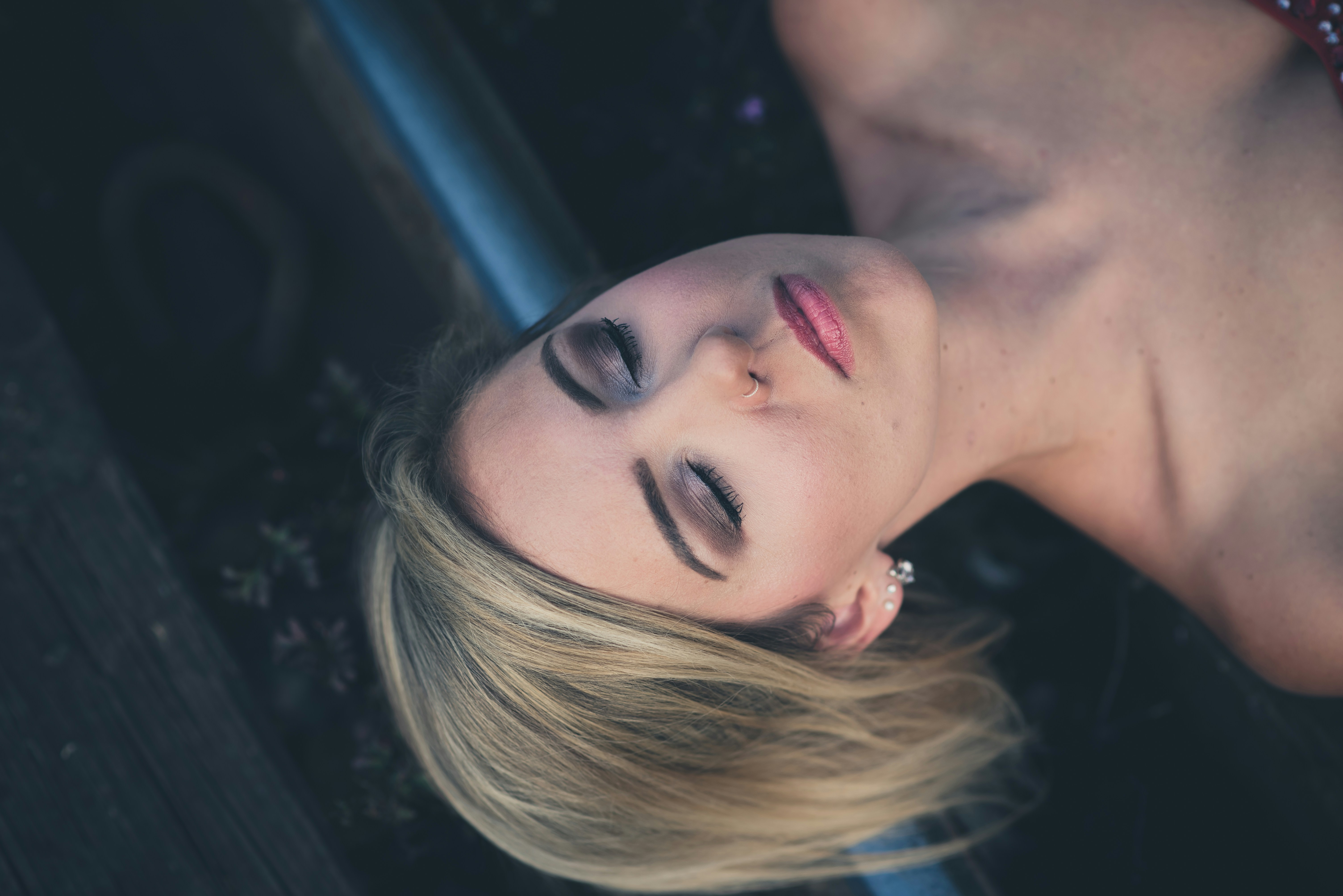 woman closing her eyes while laying on gray surface, Sleep my love, tomorrow is another day