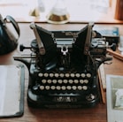 black and silver Oliver mechanical typewriter on brown wooden surface