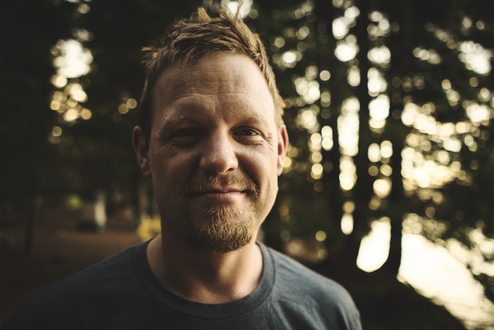 selective-focus photography of man wearing crew-neck shirt