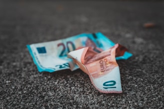 10 and 20 banknotes on concrete surface