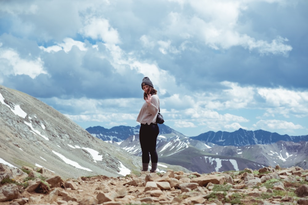 woman standing on top of mountain