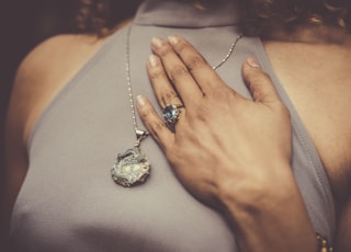 woman holding her chest close-up photo