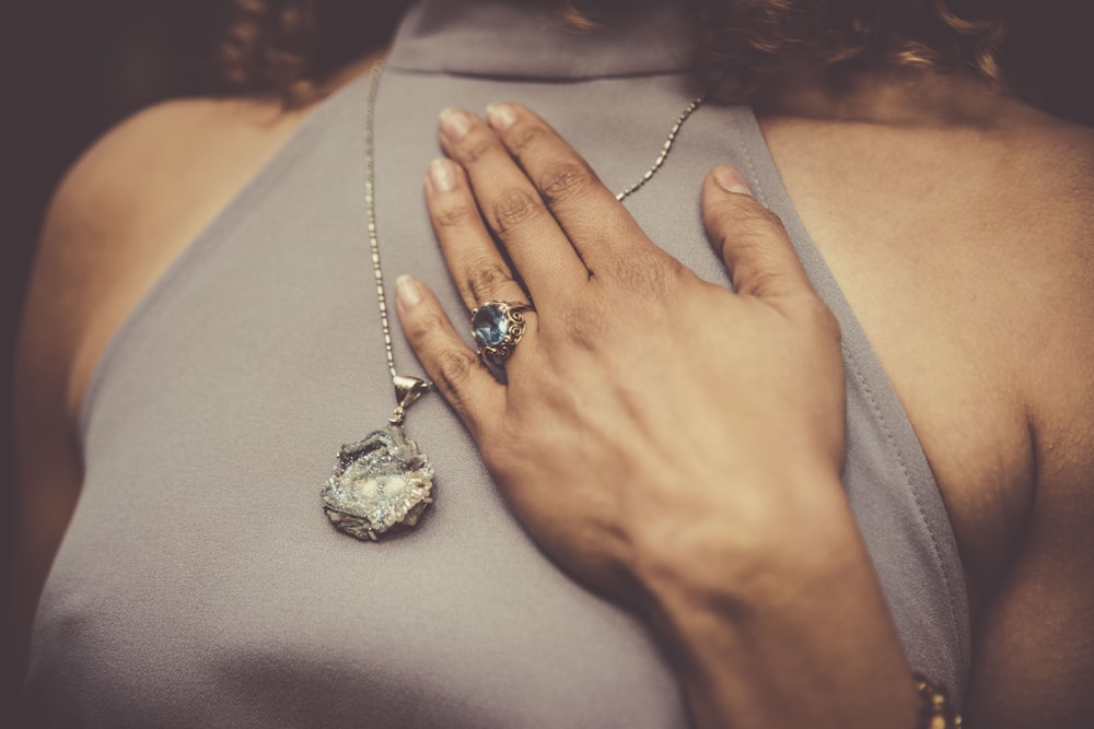 woman holding her chest close-up photo