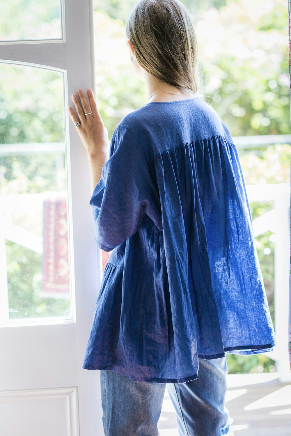 woman standing beside door