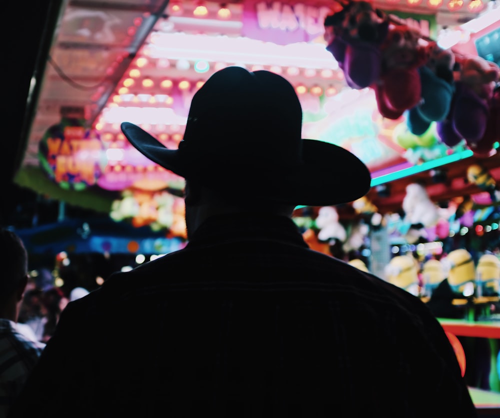 silhouette of man wearing hat