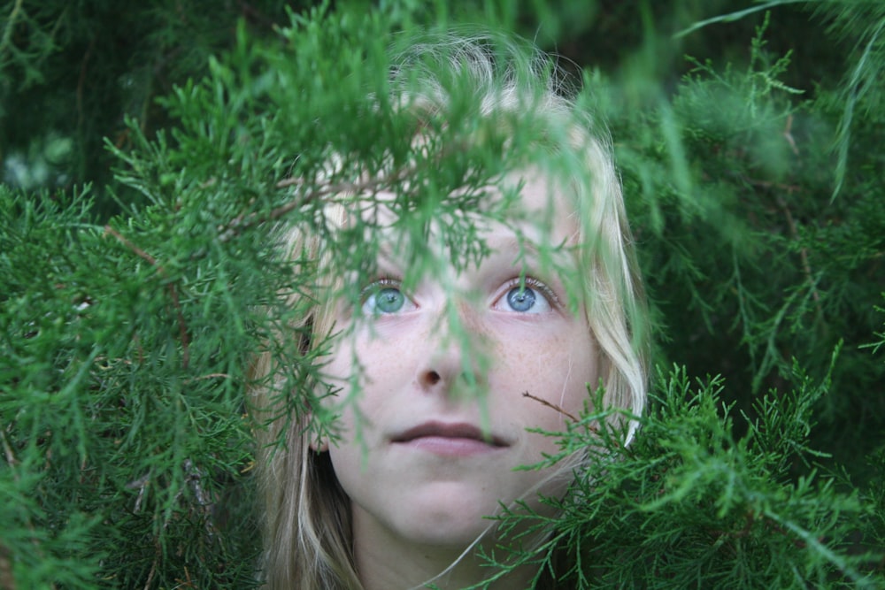 close-up photo of girl covered with plants