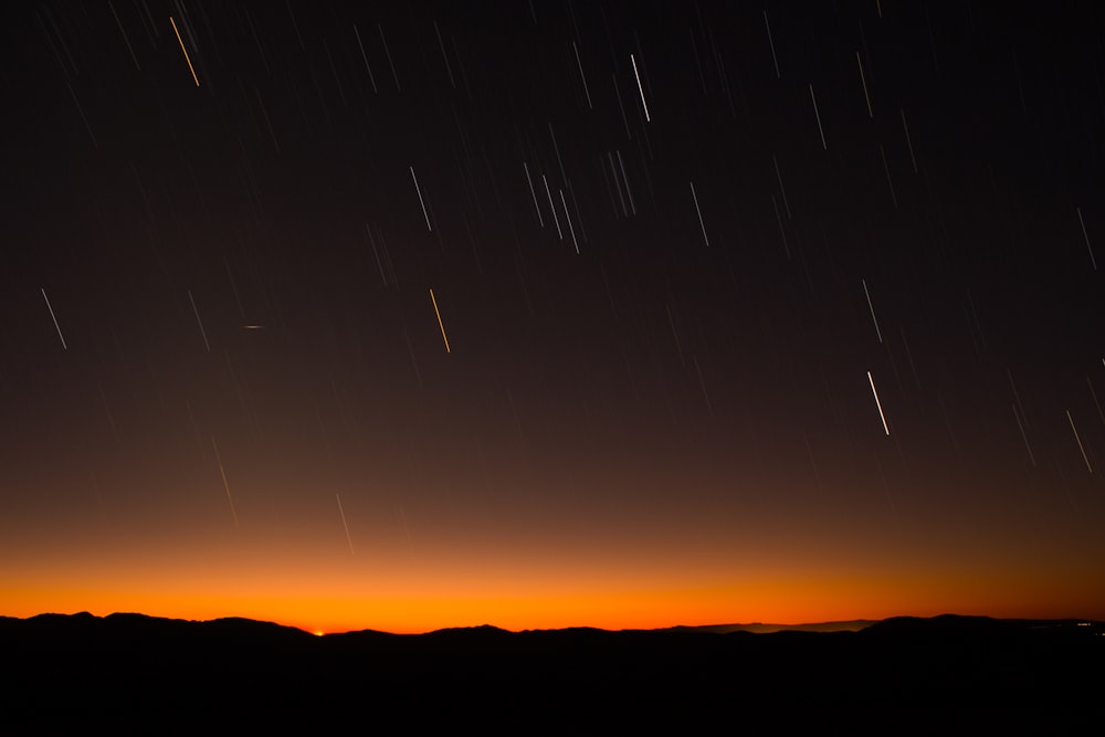 silhouette of hill during night time