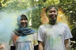 Guests smiling as they take photos at a festival.