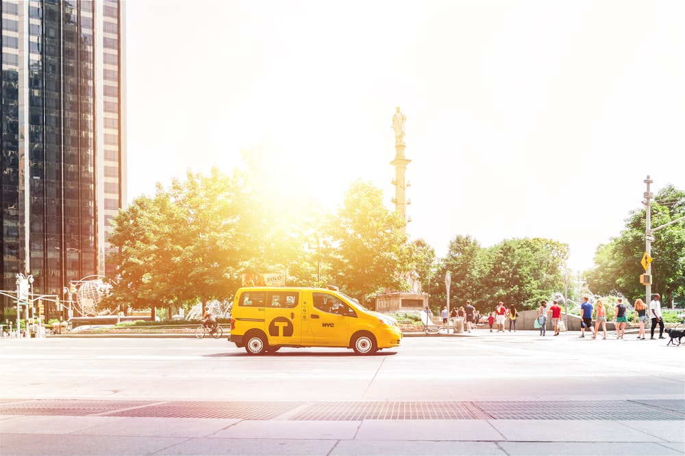 photo of yellow compact van during daytime