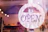 Close-up of a beautifully engraved wooden sign featuring a small business logo.