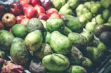 A display of assorted fresh produce alongside avocados.