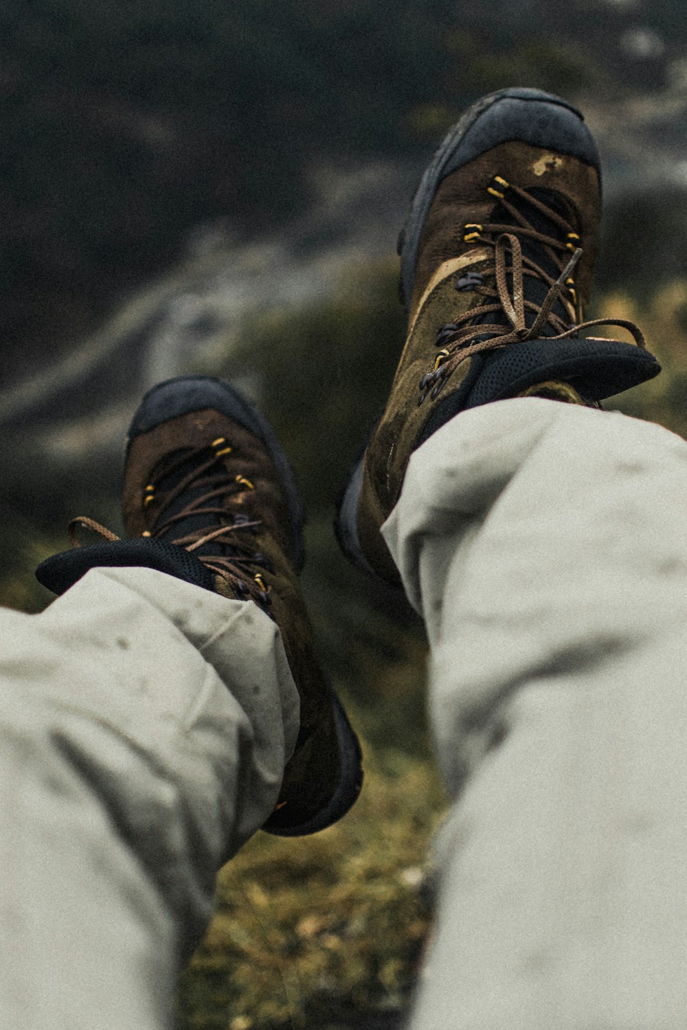 selective focus photography of person wearing hiking shoes